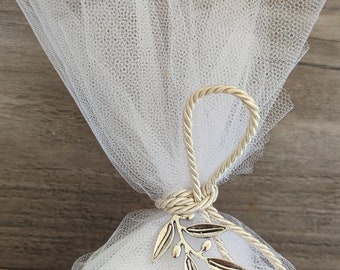 May include: A white tulle bag with a gold cord tied around the top. A silver olive branch charm is attached to the cord.