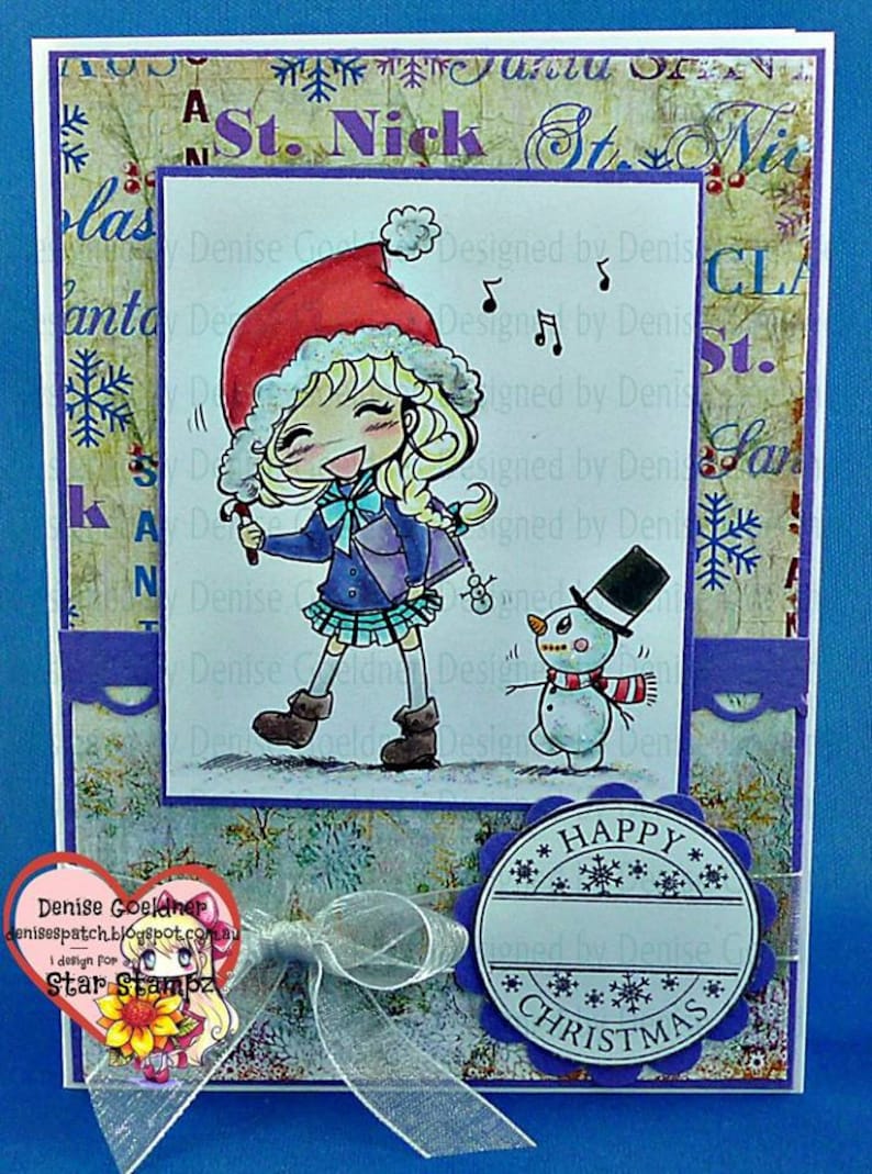 May include: A Christmas card featuring a cartoon girl wearing a red Santa hat and a blue coat, singing with a microphone. A snowman with a black top hat and red scarf stands next to her. The card has a purple border and a blue background with snowflakes. The text "Happy Christmas" is written in a circle on the bottom right corner of the card.
