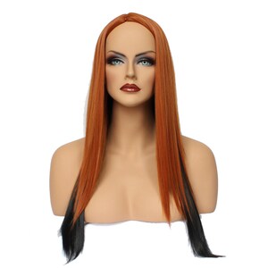 May include: A long, straight wig with black and orange streaks. The wig is styled with a center part and falls to the shoulders.