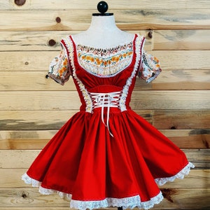 May include: A red and white dress with a floral print bodice and a lace trim. The dress has a fitted bodice and a full skirt.