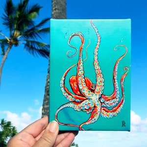 May include: A painting of an octopus with red and white tentacles on a turquoise background. The octopus is in a curled position with its tentacles reaching out in different directions. The painting is signed with the letter "R" in the bottom right corner.