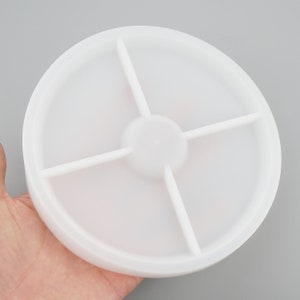 May include: White plastic round dish with four divided sections. The dish is approximately 10 inches in diameter.