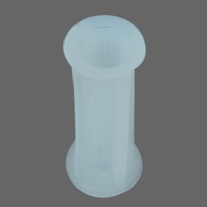 May include: White plastic connector with a ribbed design. The connector has a smooth, rounded top and a slightly flared bottom.