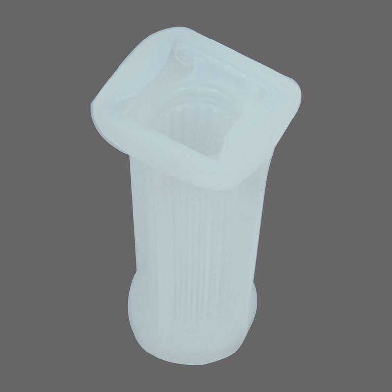 May include: White plastic mold for making a square column with a fluted design. The mold is made of silicone and has a smooth finish.