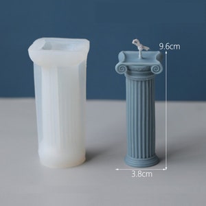 May include: A white silicone mold for making pillar candles shaped like a Roman column. The mold is 9.6 inches tall and 3.8 inches wide.