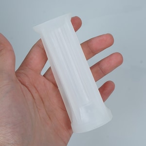 May include: White silicone mold with a rectangular shape and a smooth surface. The mold has a series of vertical lines running down the center.