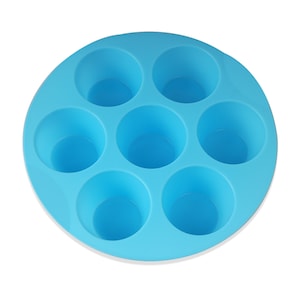 May include: A blue silicone baking mold with six round cavities. The mold is designed for making muffins, cupcakes, or other small treats.