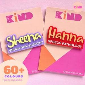 May include: Two name badges with the names "Sheena" and "Hanna" in a playful font. "Sheena" is purple with yellow lettering and says "Education Support". "Hanna" is red with yellow lettering and says "Speech Pathology". The background is pink and peach.