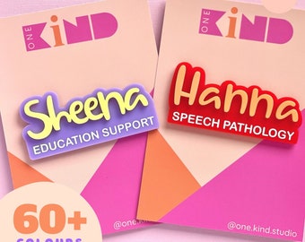 May include: Two name badges with the names "Sheena" and "Hanna" in a playful font. "Sheena" is purple with yellow lettering and says "Education Support". "Hanna" is red with yellow lettering and says "Speech Pathology". The background is pink and peach.