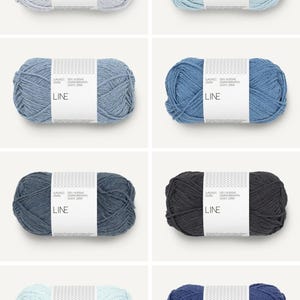 May include: An assortment of eight skeins of yarn in various shades of blue, gray, and black. Each skein is wrapped with a white label that reads "LINE". The yarn appears to be soft and suitable for knitting or crocheting projects.