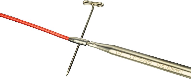 May include: A silver knitting needle with a red cord attached to the end. The needle is labeled "ChiaoGoo 10.5 (6.5mm)".
