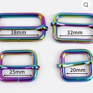 May include: Four rectangular metal sliders with a rainbow iridescent finish. The sliders are labeled with internal width measurements of 38mm, 32mm, 25mm, and 20mm. Each slider features a central horizontal bar for adjusting straps on bags or garments.