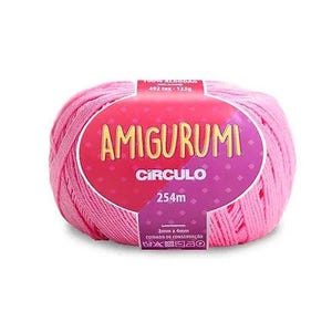 May include: A pink ball of Amigurumi yarn with a label that reads "AMIGURUMI CIRCULO 254m". The label is pink and purple with white text. The yarn is 100% cotton and is suitable for crochet projects.