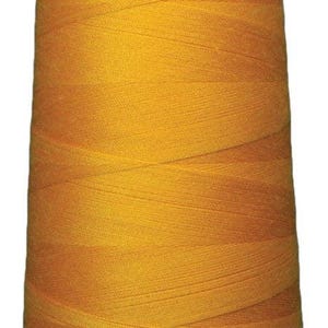 May include: A large, conical spool of vibrant golden-yellow sewing thread. The thread is tightly wound in a crisscross pattern around the central core, which features a white plastic base at the bottom and a white plastic cap at the top.