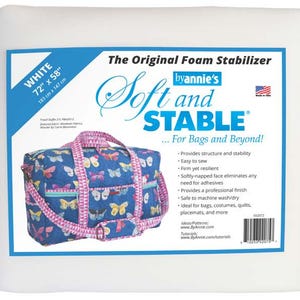 May include: White foam stabilizer with a blue and pink bag featuring a butterfly pattern. The label reads "Soft and STABLE" and includes the dimensions 72" x 58" (183 cm x 147 cm). Ideal for bags, costumes, quilts, placemats, and more.