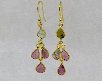 May include: Gold dangle earrings with pink, green, and white gemstone drops.