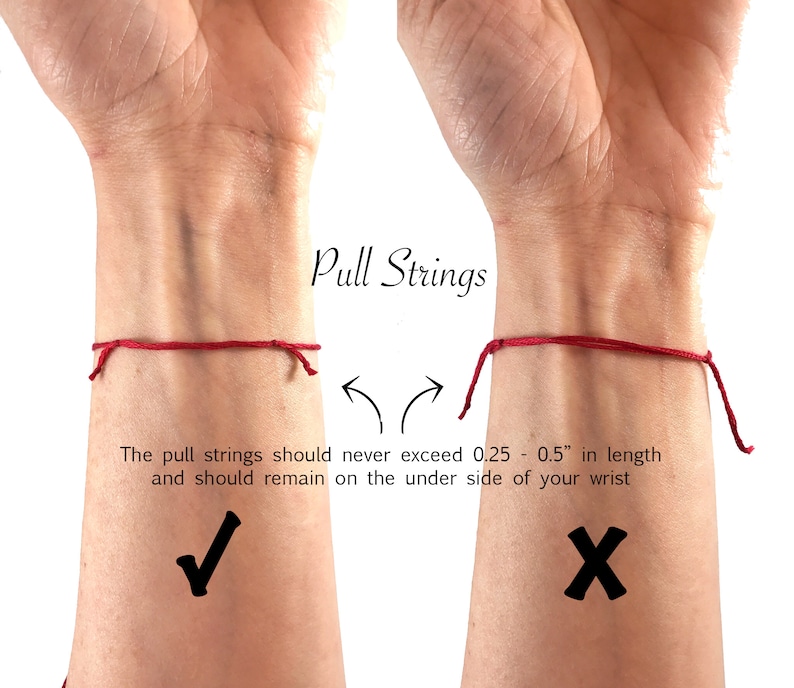 May include: A red string bracelet shown on a wrist with text instructions: Pull Strings. The pull strings should never exceed 0.25 - 0.5" in length and should remain on the under side of your wrist. A checkmark indicates the correct length.