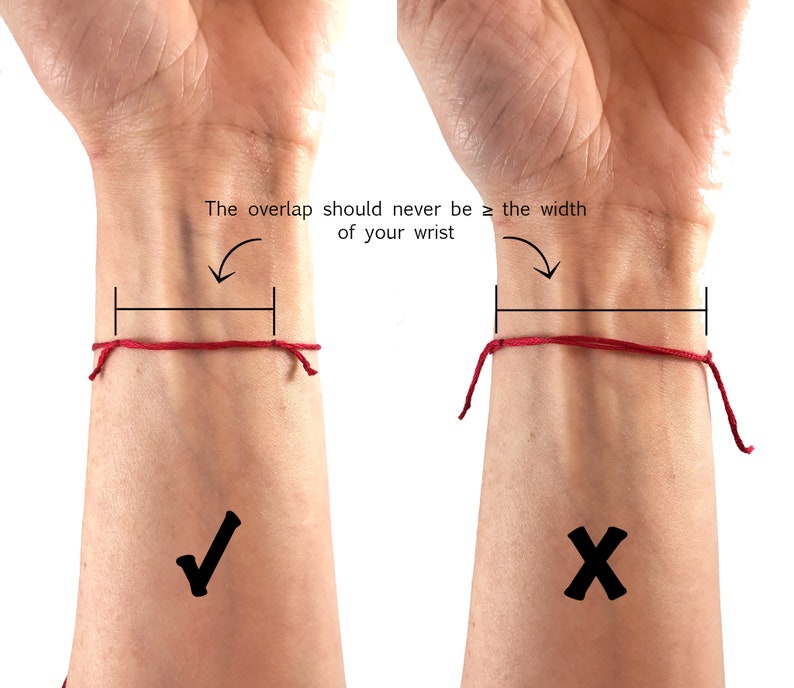May include: A thin red string bracelet tied around a wrist with a diagram showing the correct overlap length. The text reads: The overlap should never be &ge; the width of your wrist. A checkmark indicates the correct fit and an X indicates the incorrect fit.