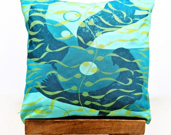 Selkie cushion, 100% organic cotton seal cushion in tropical turquoise and greens.