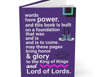 May include: A purple hardback journal with the text "words have power. and this book is built on a foundation that was and is and is to come. may these pages bring honor & glory to the King of Kings and Lord of Lords." The journal features a crown and a pair of cartoon legs wearing blue trainers.