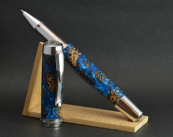 Rolling ballpoint pen made by hand from real pine cones cast in a blue resin.