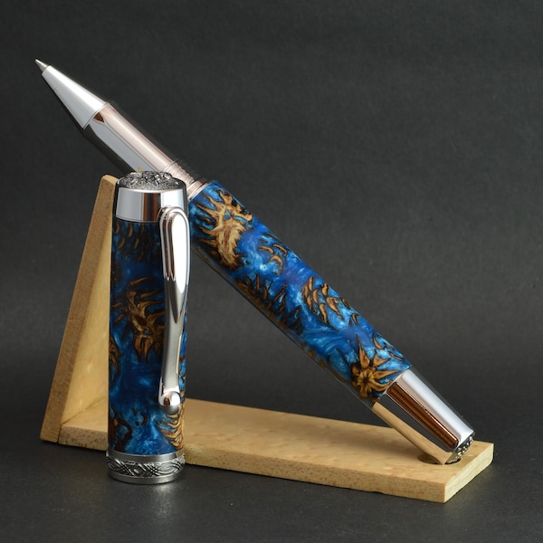 Rolling ballpoint pen made by hand from real pine cones cast in a blue resin.