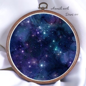 May include: A dark blue and purple watercolour painting of a starry night sky in a wooden embroidery hoop. The text "Awash with Stars 011" is written in white in the top right corner.