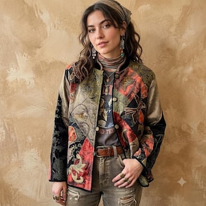 May include: A long-sleeved jacket featuring a patchwork design with black, gold, and red floral patterns. The jacket has a round neckline, a front button closure, and black trim along the edges. It is worn over a grey graphic t-shirt and brown pants.