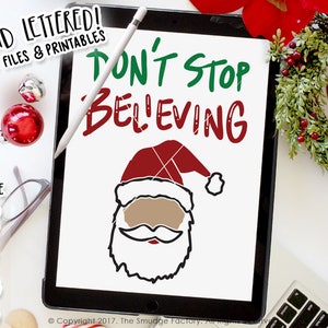 May include: A digital illustration of Santa Claus with the text "Don't Stop Believing" in green and red lettering. The image is on a white background.