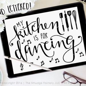 May include: Black and white hand-lettered design on a white background. The text reads "My kitchen is for dancing" with musical notes and kitchen utensils. The text "HAND LETTERED!" is in a smaller font at the top of the image.