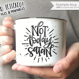 May include: White speckled ceramic mug with the phrase "Not today Satan" in black script. The mug has a black rim and is held by a person. The image also includes text that says "Hand Lettered! Cut Files & Printables" and file type options.