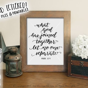 May include: A framed print with a black and white calligraphy quote that reads "What God has joined together let no one separate" with the scripture reference Mark 10:9.