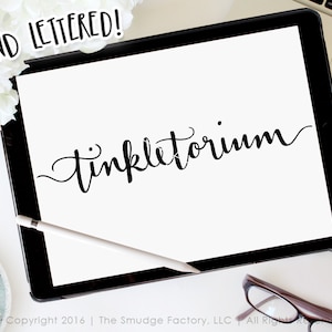 May include: Hand-lettered calligraphy on a white background. The word "tinkleatorium" is written in a cursive font.