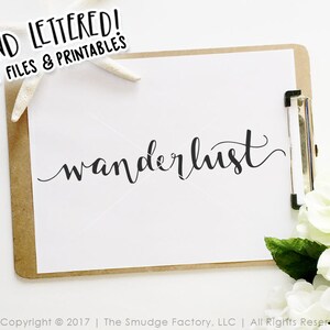May include: A white sheet of paper with the word "wanderlust" written in black cursive script on a brown clipboard. The clipboard is on a white surface with a white starfish and white flowers.