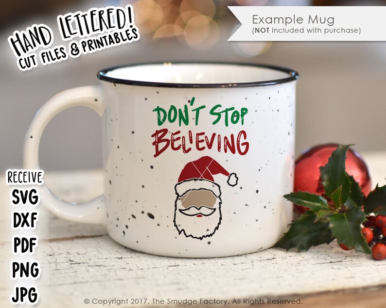 May include: White ceramic mug with a black rim and handle. The mug has a speckled design and features a green and red graphic of Santa Claus with the text "Don't Stop Beleving".