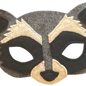 May include: A gray felt raccoon mask with black eyes and a white nose and ears. The mask is designed for children's play and costumes.