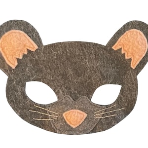 May include: A gray felt mouse mask with light orange inner ears and nose. The mask has eye holes and stitched whiskers. This costume accessory is suitable for children's dress-up or themed parties.