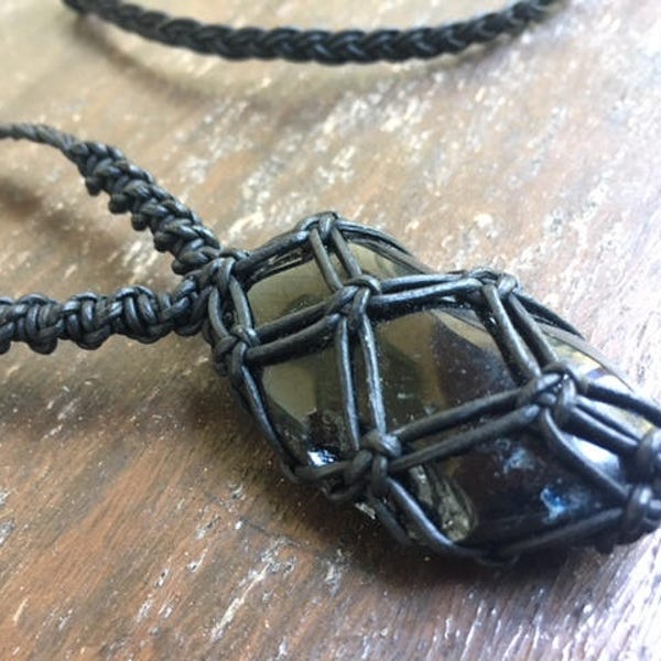 black tourmaline crystal wrapped in black leather cord