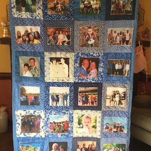 May include: A blue and white quilt with a variety of photos of people in different settings. The quilt is made of squares with a blue background and white polka dots. The photos are arranged in a grid pattern.