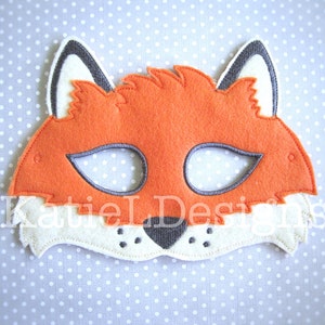 May include: A felt fox mask with orange fur, black eyes, and a white muzzle. The mask has a black felt nose and black stitching around the eyes.
