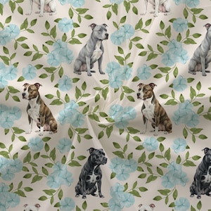 May include: Fabric with a repeating pattern of watercolor-style pit bull terriers in various colors, including gray, brown, and black. The dogs are interspersed with light blue flowers and green leaves on a cream background.