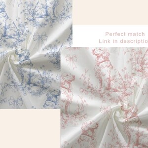 May include: White fabric with a repeating pattern of dogs, bows, and floral elements in blue and pink. The fabric is folded, showing the texture and design details. The text "Perfect match" and "Link in description" is visible.
