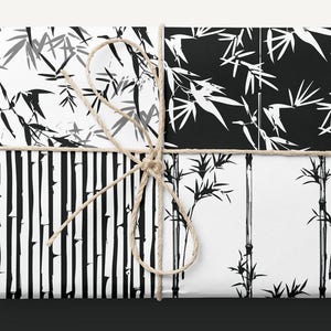 May include: A set of four black and white wrapping paper designs featuring different bamboo patterns. The papers are tied together with twine.