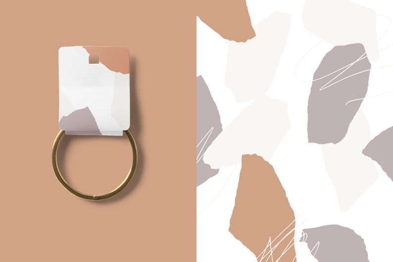May include: A gold metal bangle bracelet with a white tag featuring a torn paper design with brown, white, and gray colors.