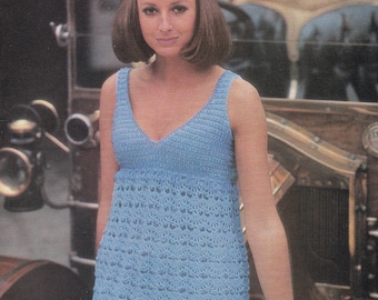 May include: A light blue crochet mini dress with a V-neckline and a scalloped hem. The dress is sleeveless and has a fitted bodice.