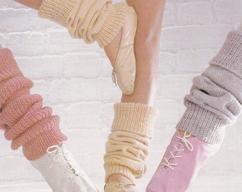 May include: Three pairs of leg warmers in pink, cream, and gray. The leg warmers are made of a soft, knitted fabric and are worn with ballet shoes or sneakers.