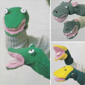 May include: Four knitted animal hand puppets. A green frog, a green alligator, a gray hippopotamus, and a yellow and blue bird. The puppets have pink mouths and are ready for play.