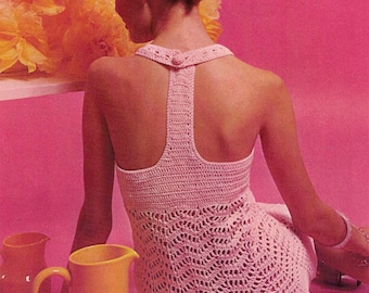 May include: A pink crochet dress with a low back and a button detail. The dress is made with a delicate stitch pattern and has a flowing silhouette.