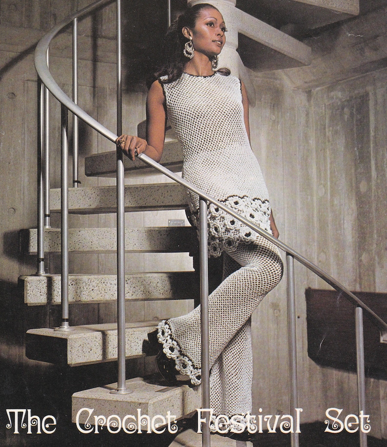 May include: A woman wearing a white crochet dress and pants set. The dress has a crocheted lace trim and the pants are flared. The woman is standing on a staircase.
