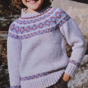May include: A light purple sweater with a geometric pattern in blue and maroon around the yoke and cuffs. The sweater has a ribbed collar, cuffs, and hem. The sweater is made of a soft, knitted material.